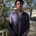 High school male student stands on bridge