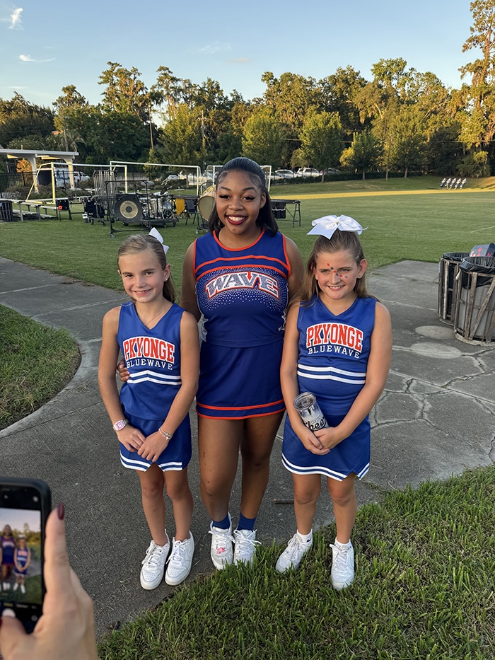 Three girls in cheer uniforms
